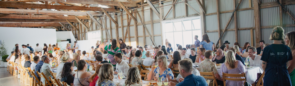 People sitting at tables and eating inside The Cargo Shed
